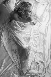 blonde lady wearing a white silk sheet