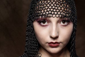 cinematic portrait - headshot of female wearing chain mail headdress