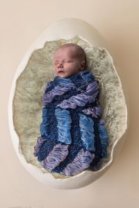 Newborn baby in an eggshell